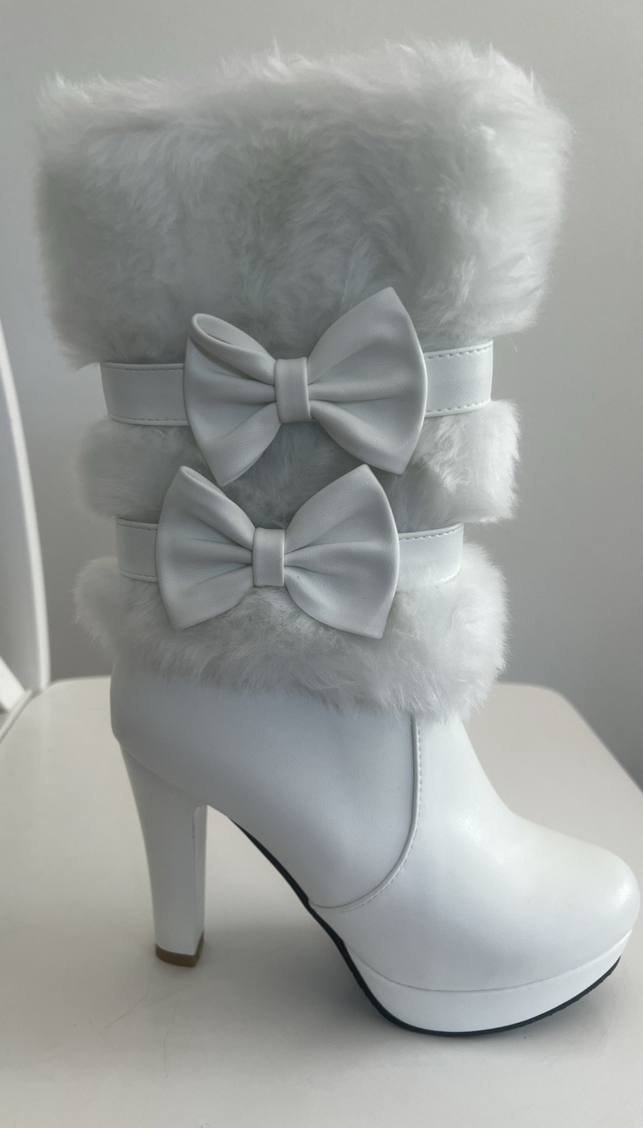 White Boots With Fur and bows. They are new.  Size 35 or Size 5.  Not refundable
